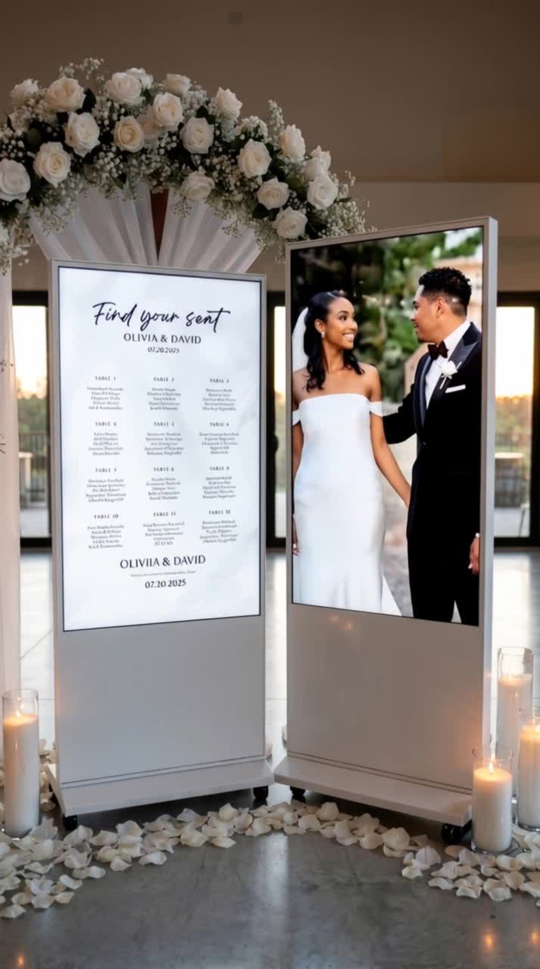 Duo screens with floral arch showing seating chart and couple